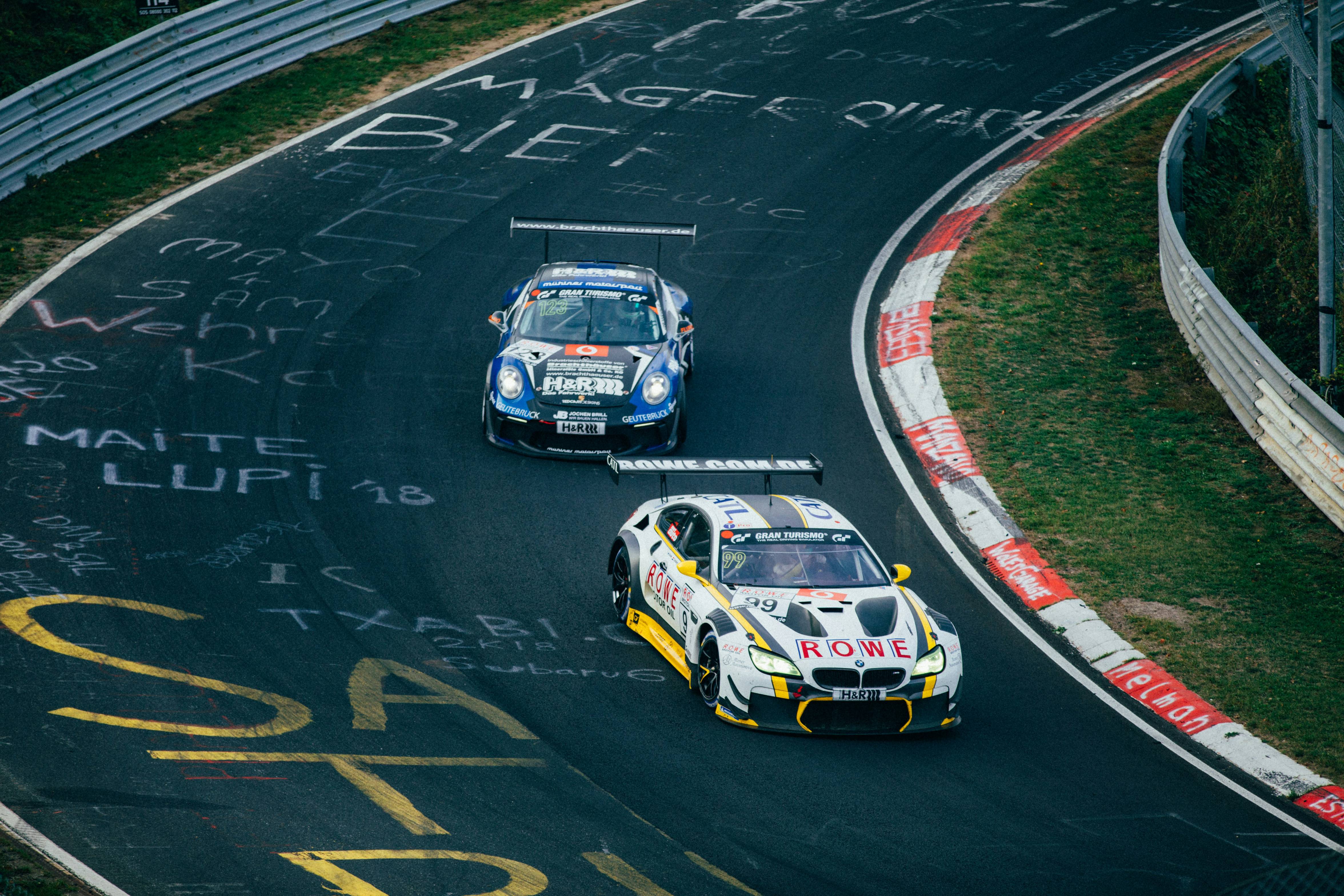 Two running cars on race track
