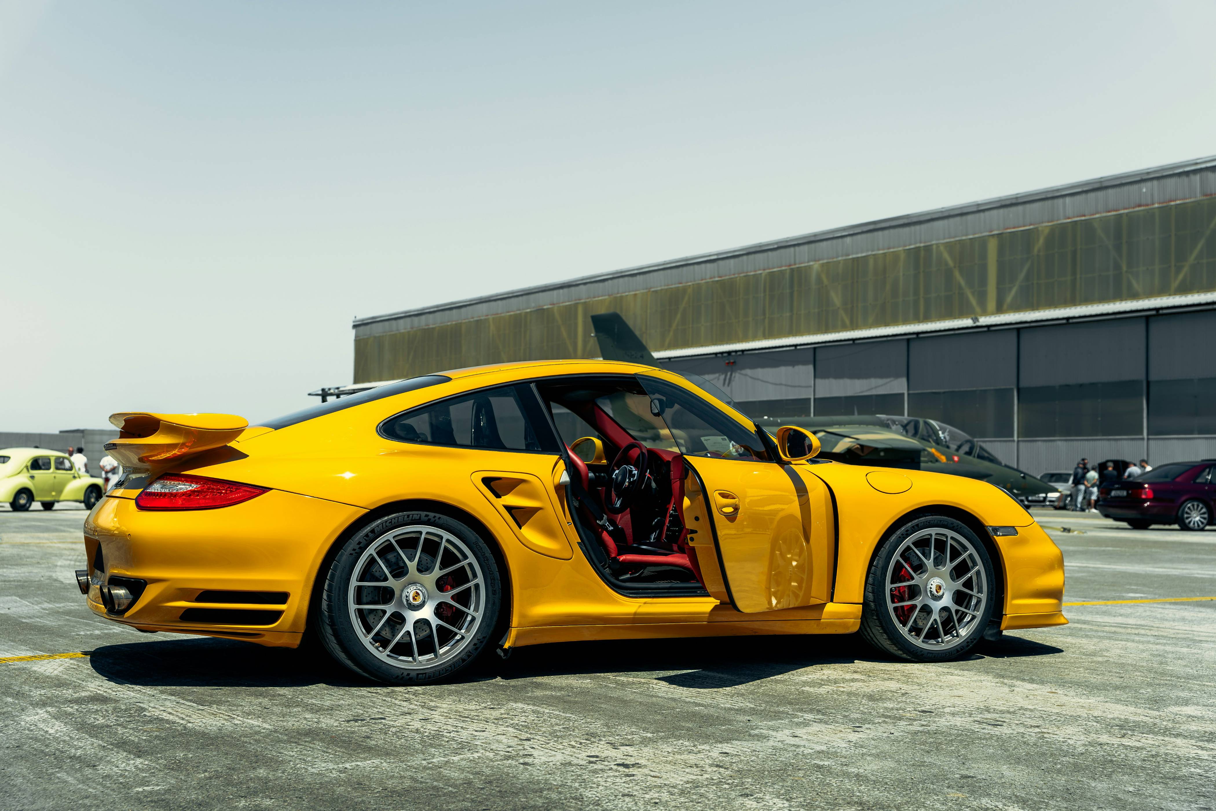 A yellow sports car parked in a parking lot