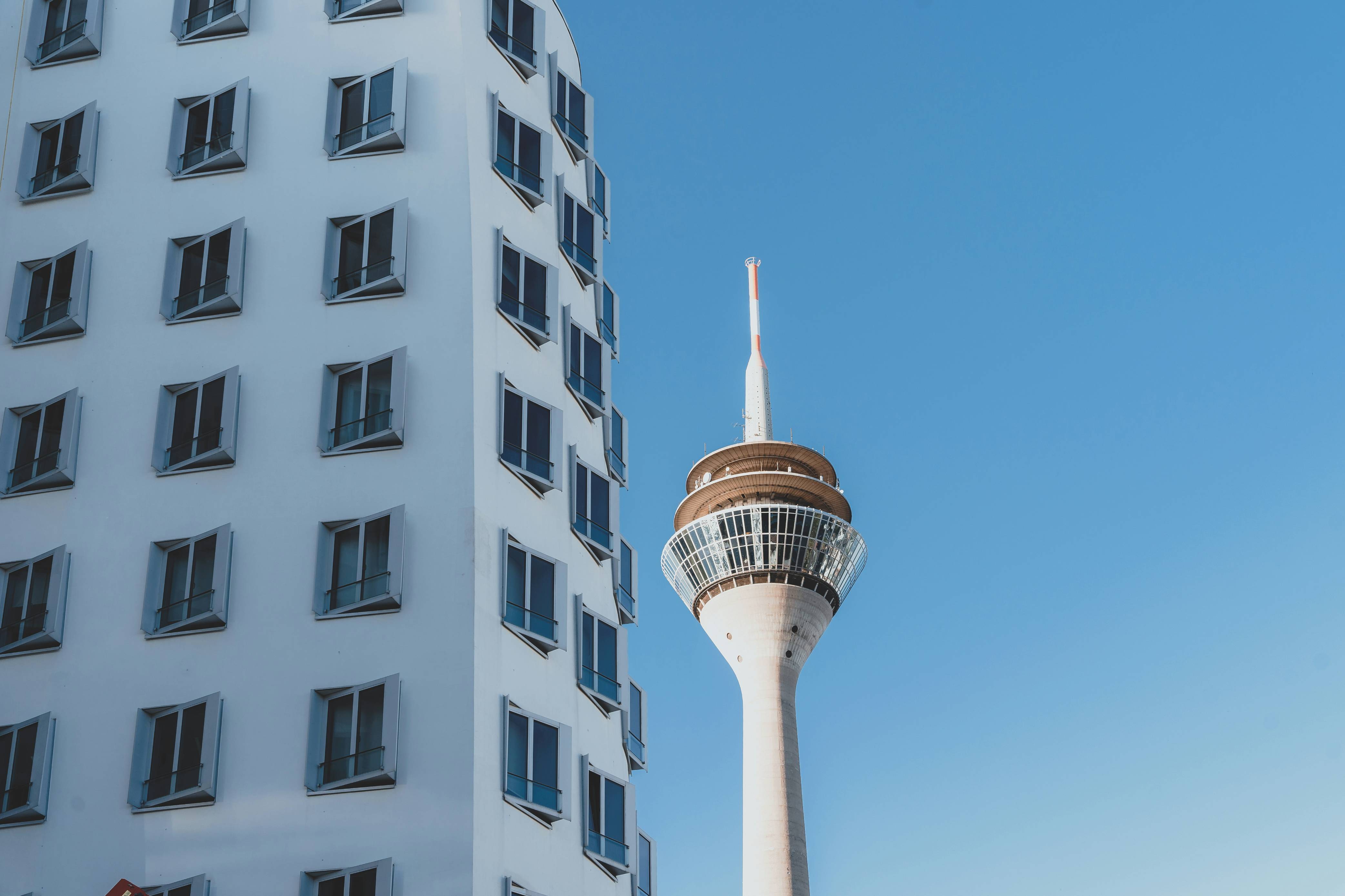 a tall white building next to a tall white building
