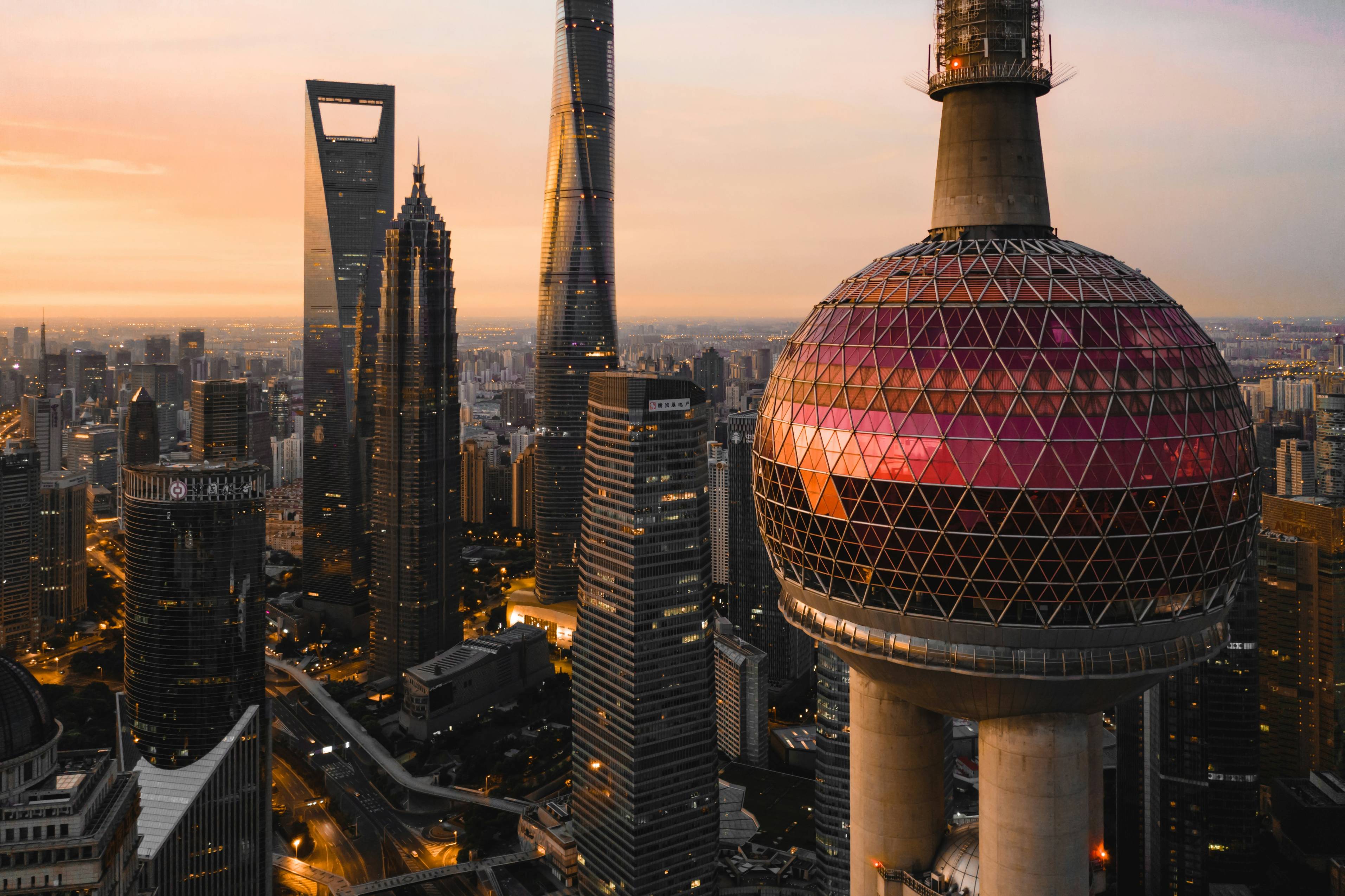a view of a city at sunset from the top of a skyscraper